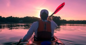 Man Kayaking at Sunset